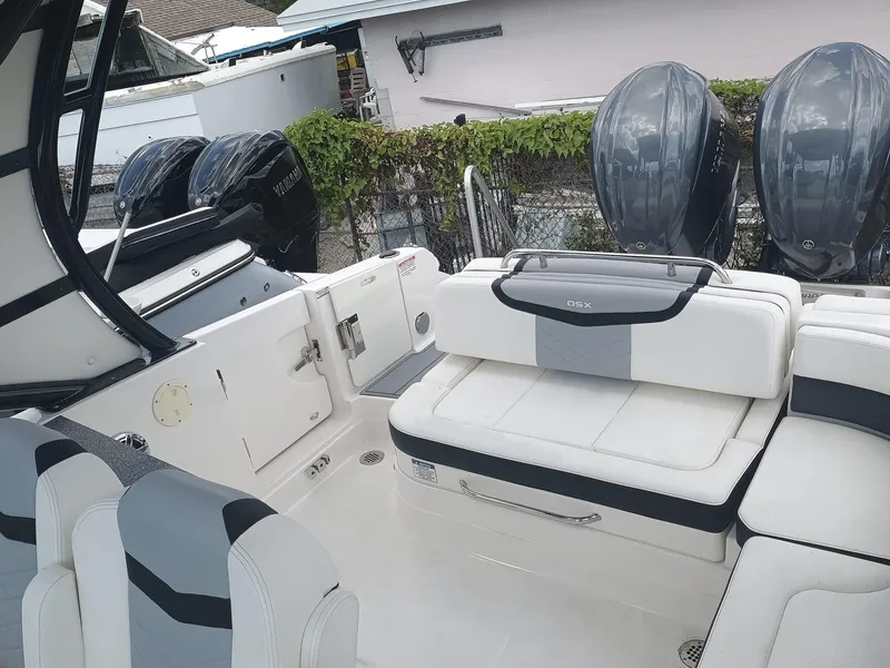 Slide: The Image of 2024 Chaparral 280 OSX boat interior with seating and dual outboard engines. - 22