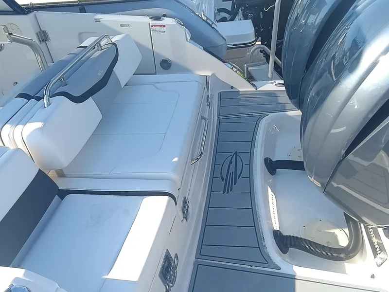 Slide: The Image of 2024 Chaparral 280 OSX boat interior with seating and engine area. - 27