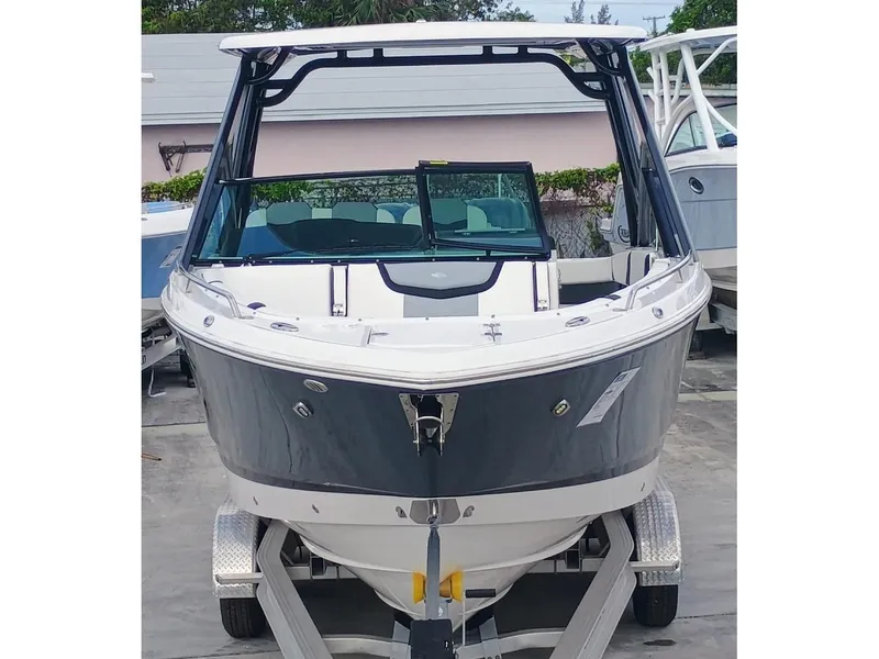 Slide: The Image of 2024 Chaparral 280 OSX boat on trailer, front view, sleek design. - 3