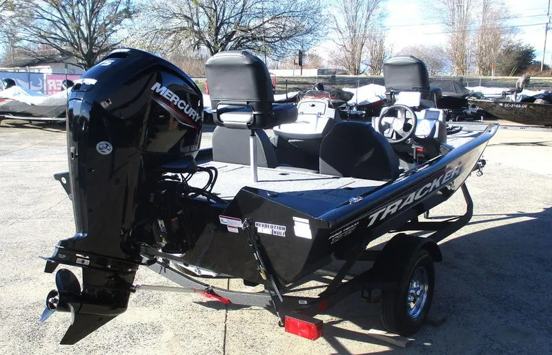 Slide: The Image of 2025 Tracker Pro Team™ 175 TXW boat with Mercury engine, parked outdoors. - 3