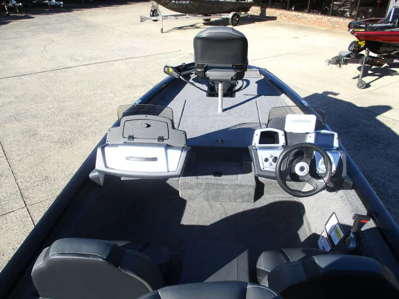 Slide: The Image of 2025 Tracker Pro Team™ 175 TXW boat interior with steering console and seating. - 5