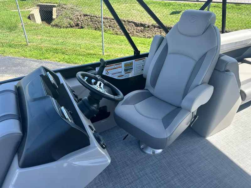 Slide: The Image of Captain's seat and helm of 2025 Premier 220 Sunscape RF boat, featuring modern design. - 10