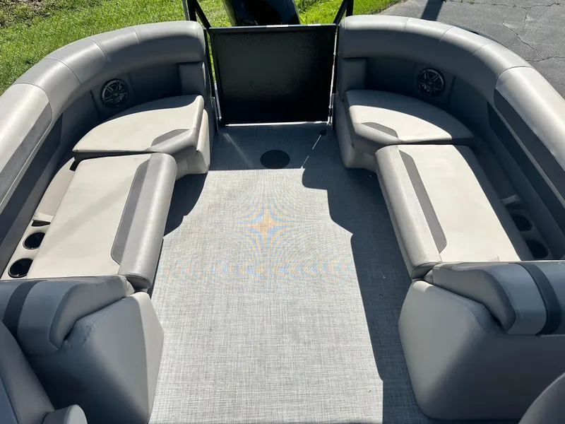 Slide: The Image of 2025 Premier 220 Sunscape RF boat interior with gray seating and carpet. - 11