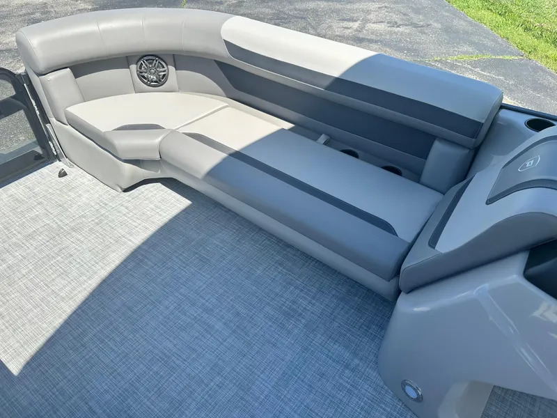 Slide: The Image of 2025 Premier 220 Sunscape RF boat interior with gray seating and speaker. - 14
