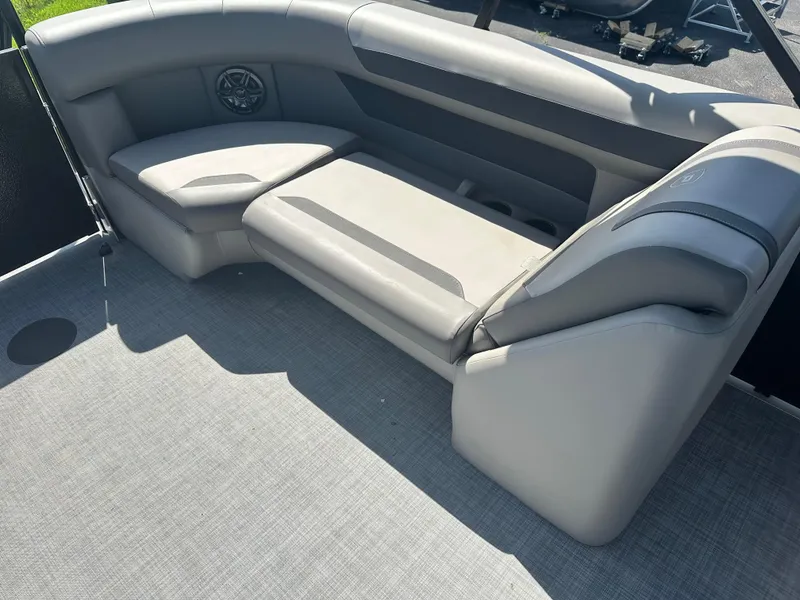 Slide: The Image of 2025 Premier 220 Sunscape RF boat interior with gray seating and speaker. - 16
