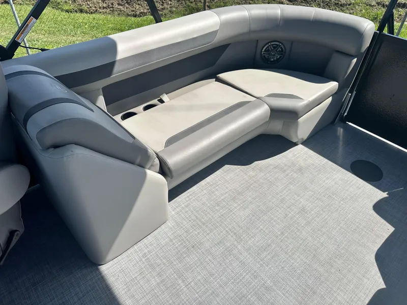 Slide: The Image of 2025 Premier 220 Sunscape RF boat interior with gray seating and speaker. - 17
