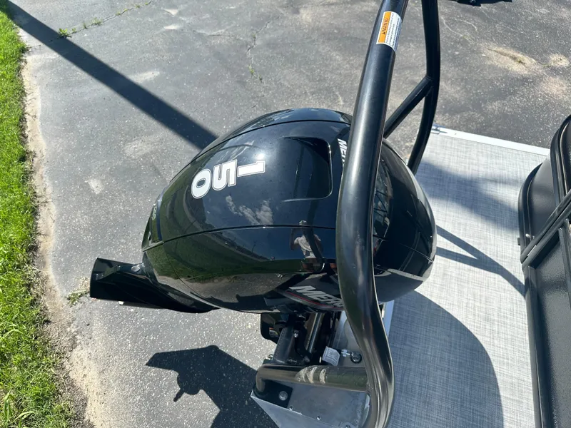 Slide: The Image of Outboard motor on 2025 Premier 220 Sunscape RF boat, parked on pavement. - 18