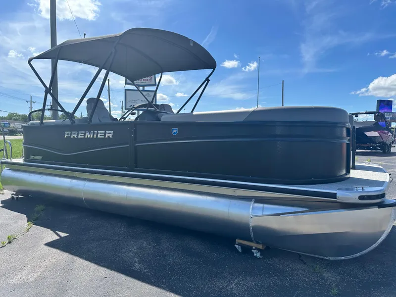 Slide: The Image of 2025 Premier 220 Sunscape RF pontoon boat with canopy, parked outdoors under blue sky. - 6