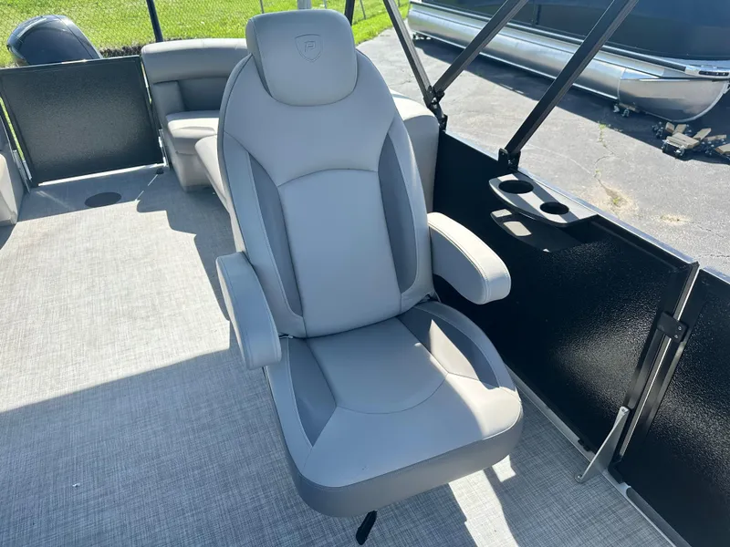 Slide: The Image of Premier 220 Sunscape RF 2025 boat seat, gray upholstery, armrests, outdoor setting. - 9