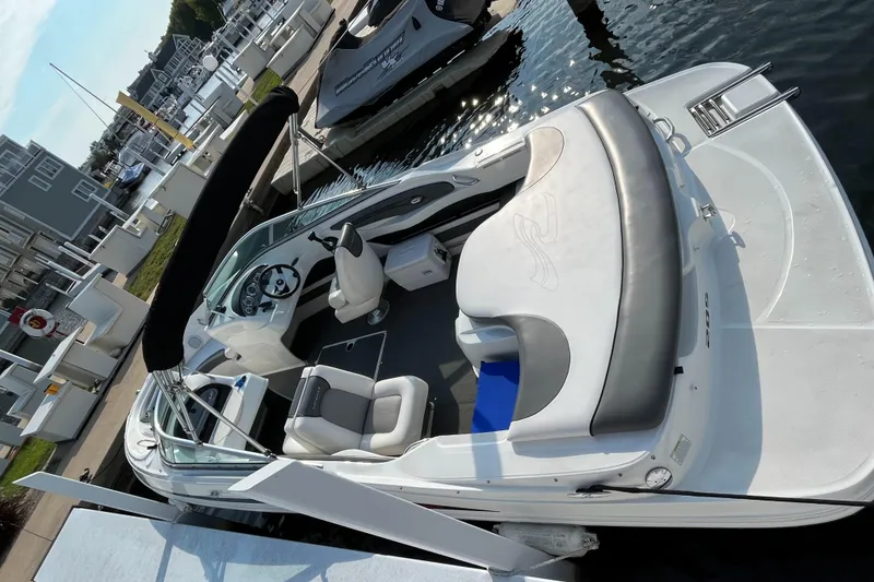 Slide: The Image of 2011 Sea Ray 205 Sport boat docked at marina, featuring sleek design and comfortable seating. - 5
