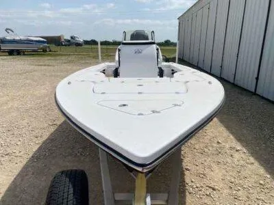 Slide: The Image of 2025 Blazer 675 Ultimate Bay boat on trailer, parked outdoors near a storage facility. - 2