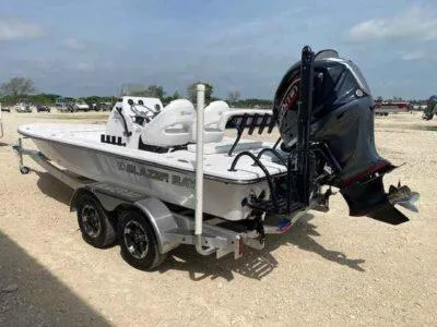 Slide: The Image of 2025 Blazer 675 Ultimate Bay boat with dual-axle trailer and powerful outboard motor. - 5