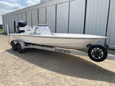 Slide: The Image of 2025 Blazer 675 Ultimate Bay boat on Sport Trail trailer, parked outdoors. - 6