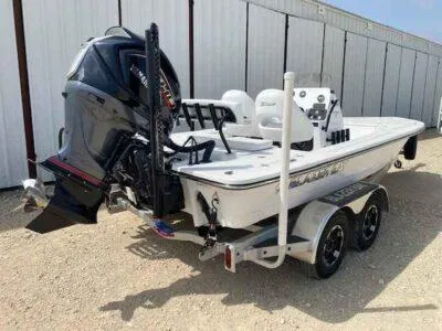 Slide: The Image of 2025 Blazer 675 Ultimate Bay boat on trailer, featuring powerful outboard motor. - 7