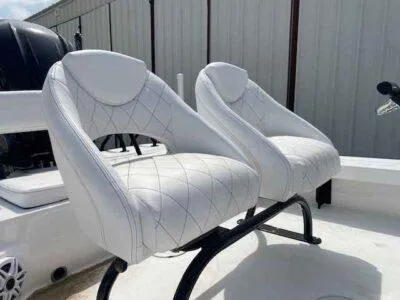 Slide: The Image of 2025 Blazer 675 Ultimate Bay boat with white cushioned seats. - 9