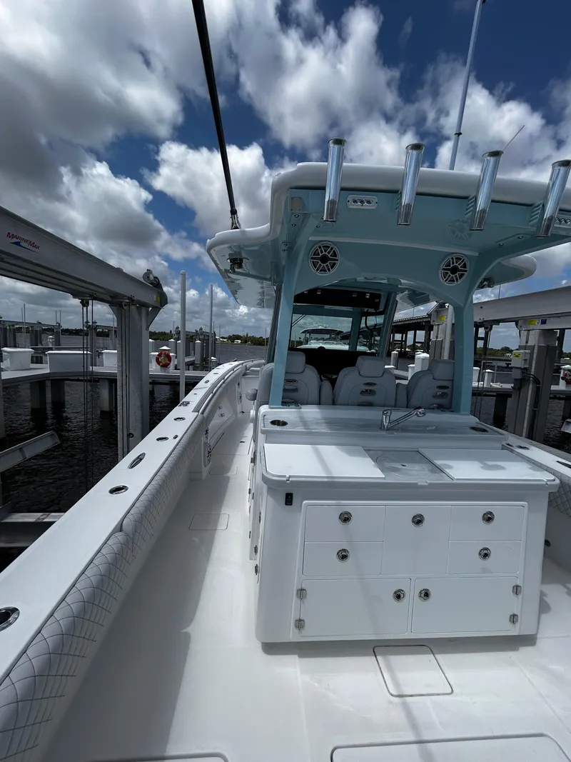 Slide: The Image of 2023 HCB 39 Speciale boat docked under a cloudy sky. - 12