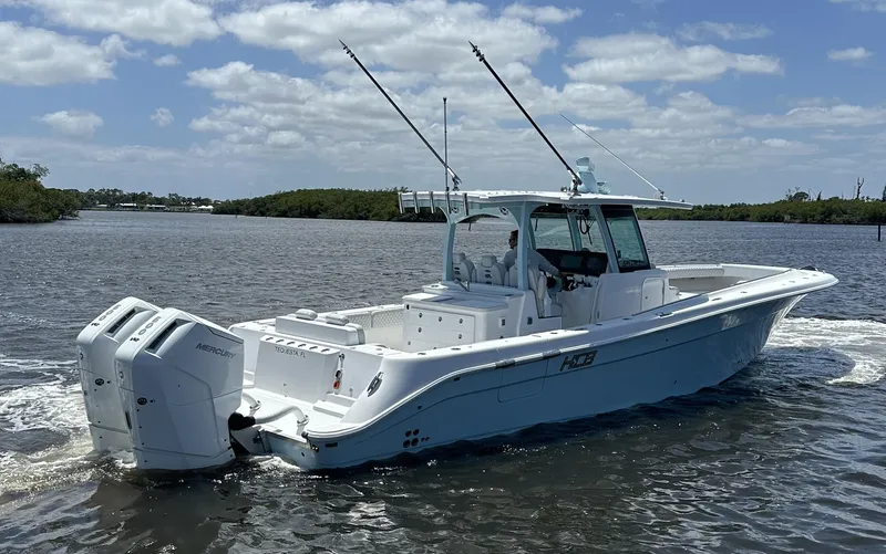 Slide: The Image of 2023 HCB 39 Speciale boat on water with dual engines and fishing rods. - 18