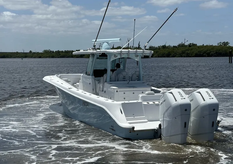 Slide: The Image of 2023 HCB 39 Speciale boat with dual engines cruising on a calm river. - 21