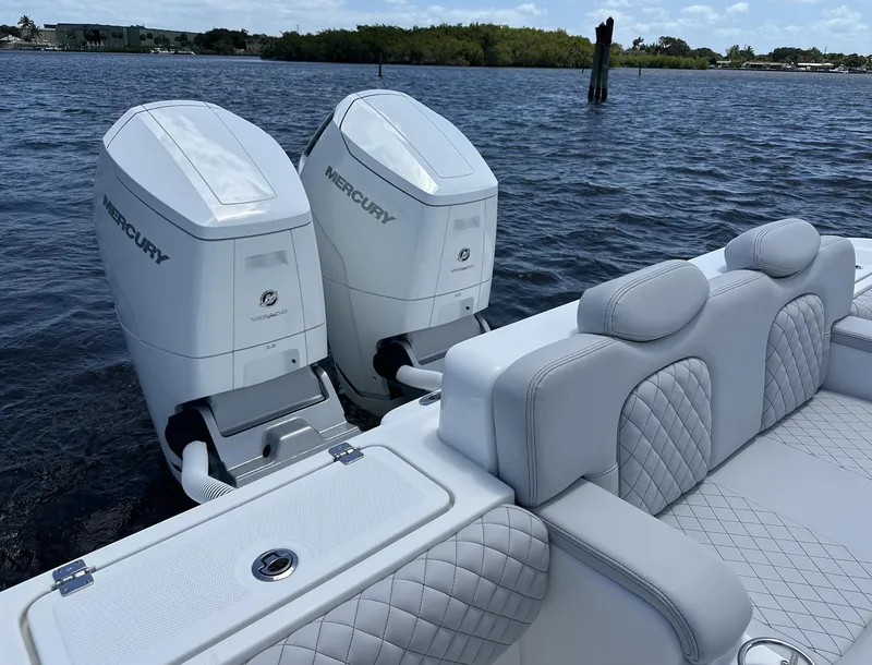 Slide: The Image of 2023 HCB 39 Speciale boat with dual Mercury outboard engines on a calm water backdrop. - 23