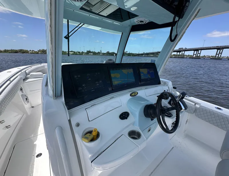 Slide: The Image of 2023 HCB 39 Speciale boat dashboard with navigation screens on a sunny day. - 28