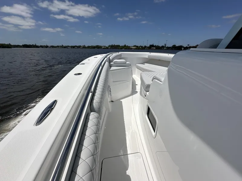 Slide: The Image of 2023 HCB 39 Speciale boat with sleek white deck and luxurious seating on open water. - 29