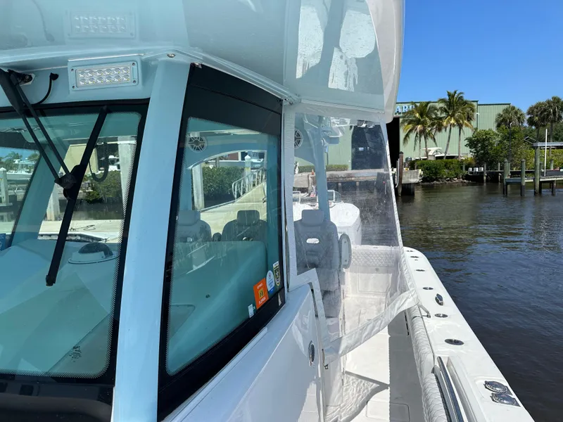 Slide: The Image of 2023 HCB 39 Speciale boat docked by a waterfront, clear skies. - 9