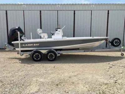 The Image of 2025 Blazer Bay 2220 Fisherman boat on trailer, parked outdoors. - 0