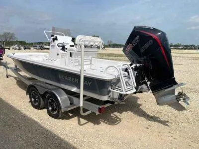 Slide: The Image of 2025 Blazer Bay 2220 Fisherman boat on trailer with powerful outboard motor. - 4
