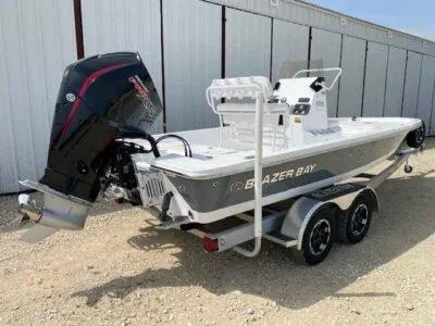 Slide: The Image of 2025 Blazer Bay 2220 Fisherman boat on trailer, parked outdoors. - 6