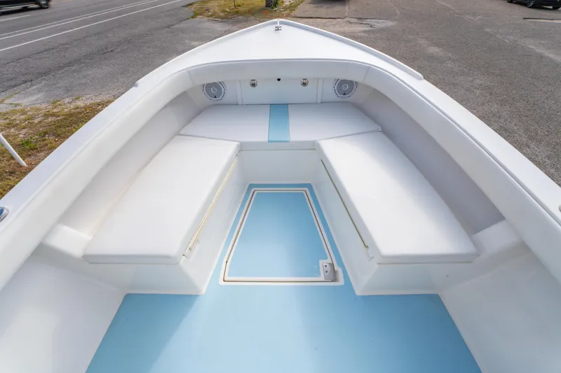 Slide: The Image of 2016 Albury Brothers 23 boat interior with white seating and light blue deck. - 12