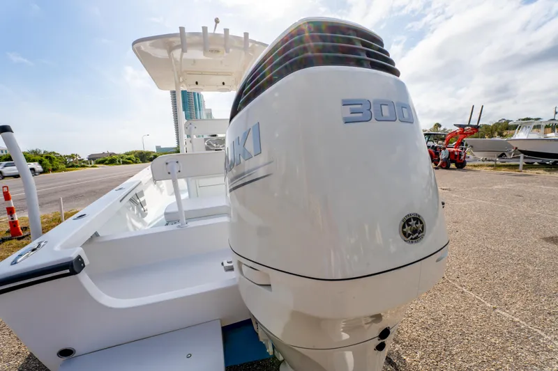 Slide: The Image of 2016 Albury Brothers 23 boat with Suzuki 300 outboard motor, parked outdoors. - 14