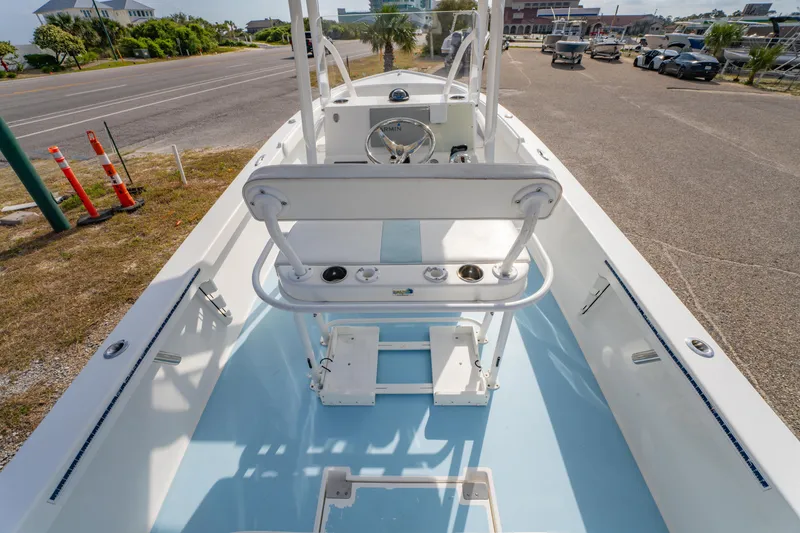Slide: The Image of 2016 Albury Brothers 23 boat interior with steering console, parked near a road. - 19