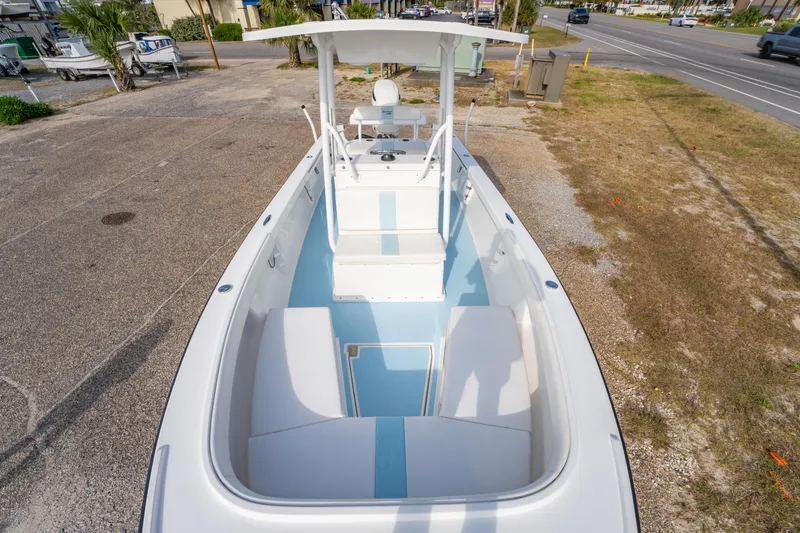Slide: The Image of 2016 Albury Brothers 23 boat with center console, parked on a lot near a road. - 23