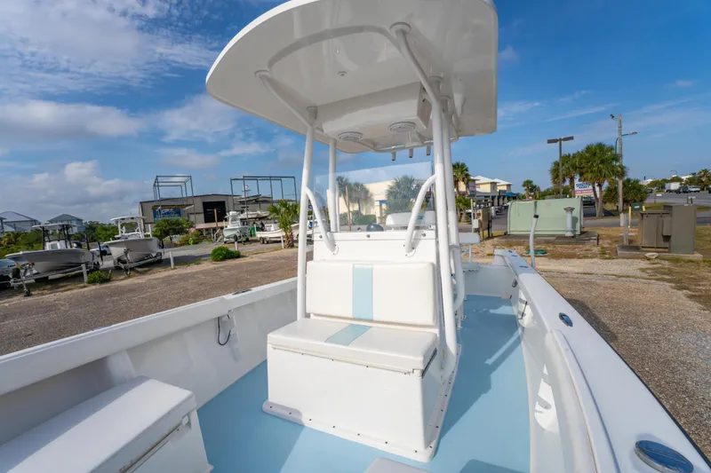 Slide: The Image of 2016 Albury Brothers 23 boat with center console, white and blue interior, parked outdoors. - 24