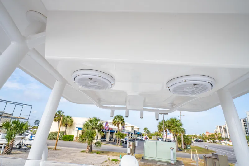 Slide: The Image of 2016 Albury Brothers 23 boat canopy with speakers, street view in background. - 25