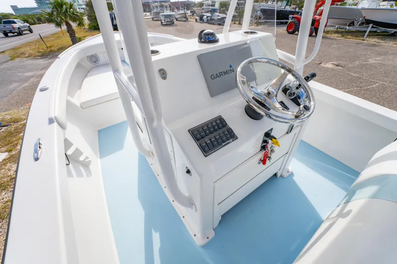 Slide: The Image of 2016 Albury Brothers 23 boat cockpit with Garmin navigation system and steering wheel. - 8