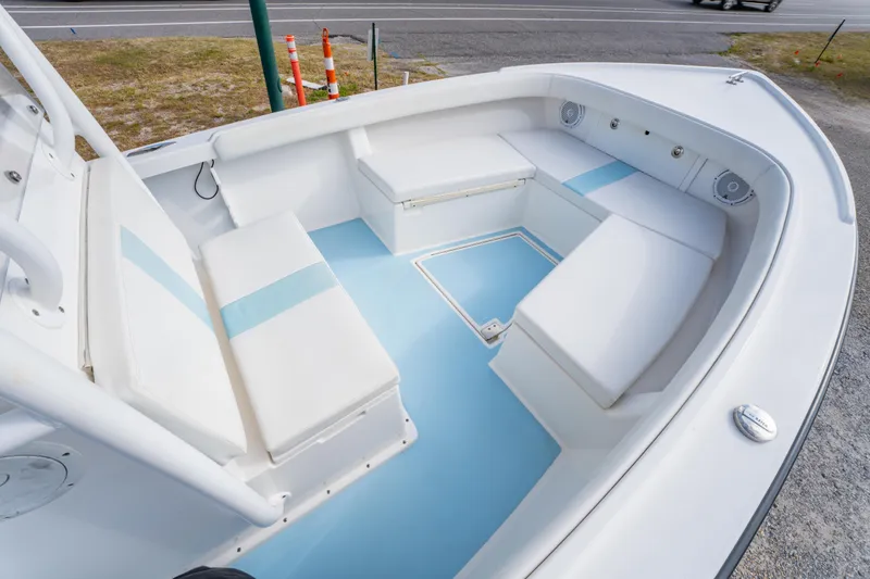 Slide: The Image of 2016 Albury Brothers 23 boat interior with white seating and blue accents. - 9