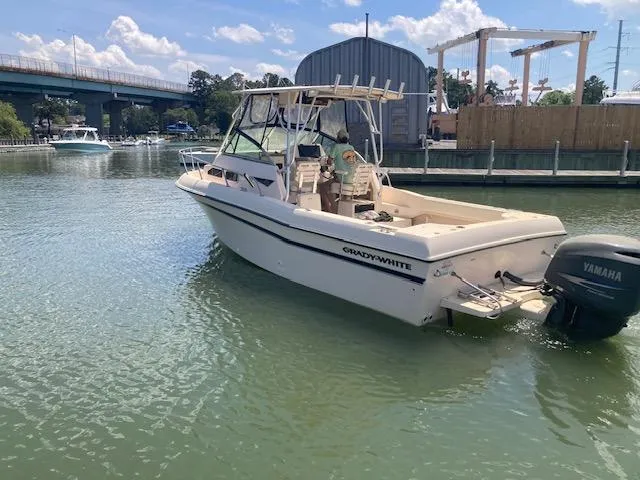 Slide: The Image of 1997 Grady-White 232 Gulfstream boat with Yamaha motor on calm water. - 0