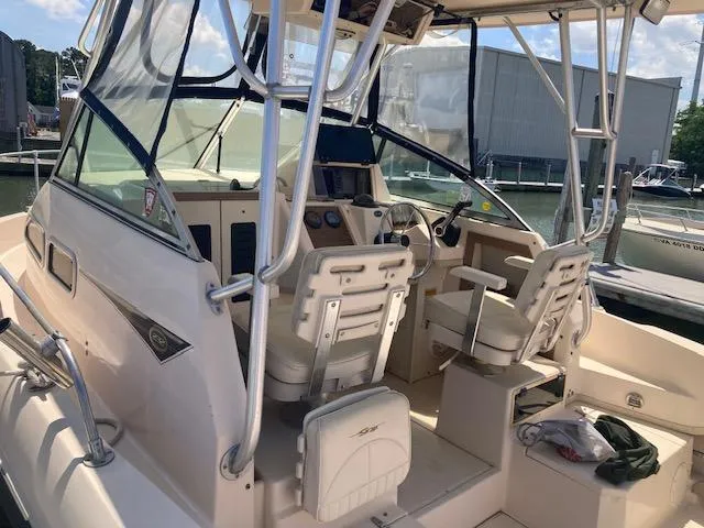 Slide: The Image of 1997 Grady-White 232 Gulfstream boat interior with helm and seating area. - 2