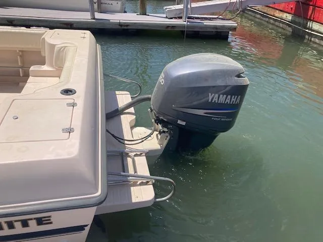 Slide: The Image of 1997 Grady-White 232 Gulfstream boat with Yamaha outboard motor docked in water. - 3