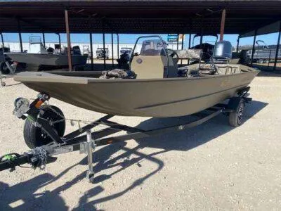 Slide: The Image of 2025 G3 Gator Tough 18 CCJ boat on trailer in outdoor showroom. - 2