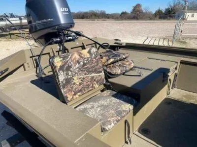 Slide: The Image of 2025 G3 Gator Tough 18 CCJ boat with camouflage seating and powerful outboard motor. - 7