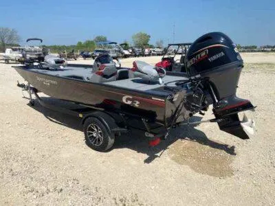 Slide: The Image of 2025 G3 Sportsman 1710 boat with Yamaha motor on a trailer in a parking area. - 4