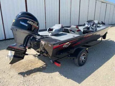 Slide: The Image of 2025 G3 Sportsman 1710 boat with Yamaha motor, parked on gravel near a metal building. - 6