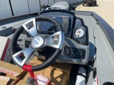 Slide: The Image of 2025 G3 Sportsman 1710 PFX boat dashboard with steering wheel and navigation controls. - 7