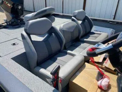 Slide: The Image of 2025 G3 Sportsman 1710 PFX boat interior with gray seating and steering wheel. - 8