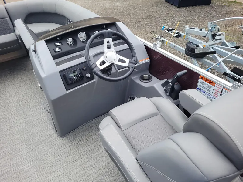 Slide: The Image of 2020 Bennington 22 SSBXP boat interior with steering wheel and seating. - 1