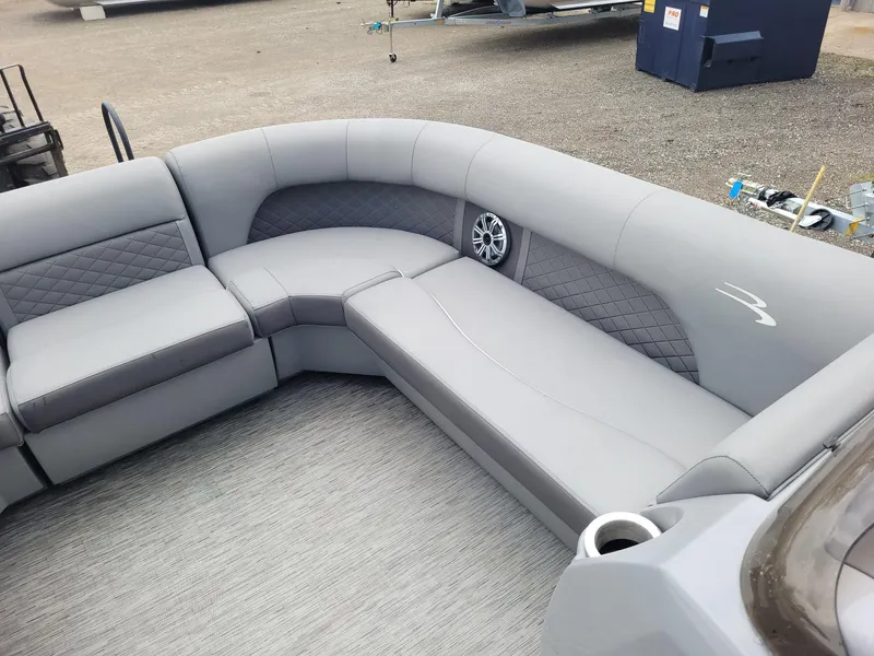 Slide: The Image of 2020 Bennington 22 SSBXP pontoon boat interior with gray seating and speaker. - 2