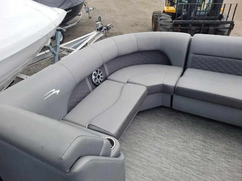 Slide: The Image of 2020 Bennington 22 SSBXP boat interior with gray cushioned seating and speaker. - 3