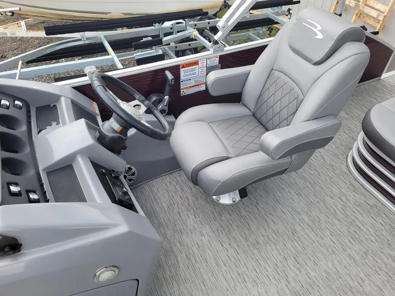 Slide: The Image of 2020 Bennington 22 SSBXP boat interior with gray captain's chair and steering console. - 6